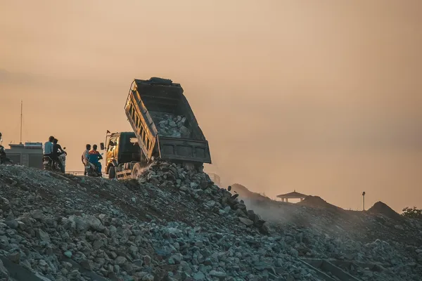Garbage truck dumping waste at a landfill