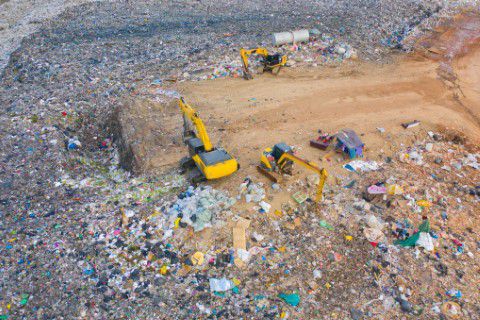 Aerial view of a machine cleaning in a landfill