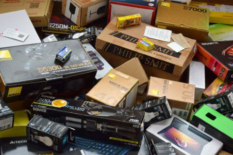 Electronic equipment in boxes ready to be trashed