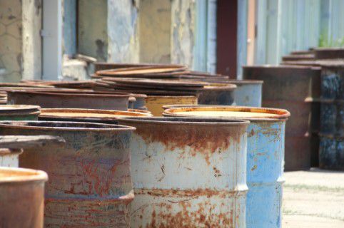 Rusted barrels sitting at a transfer station